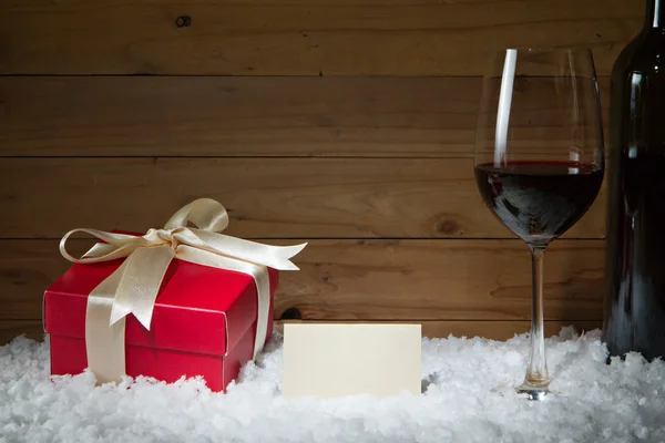 Concept of celebration with gift box, empty card, wine glass on