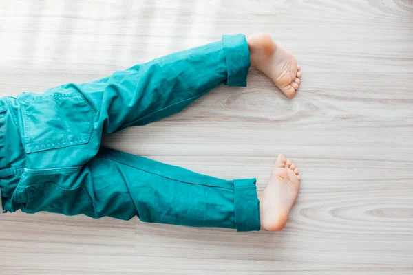 Child laying down on the floor