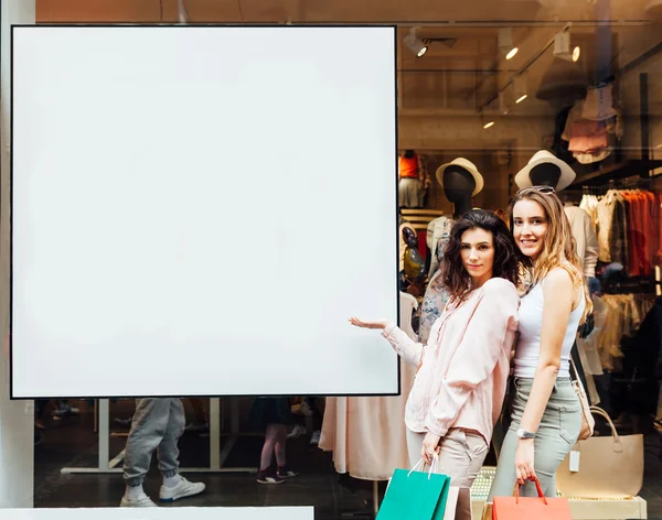 Women in front of  boutique showcase