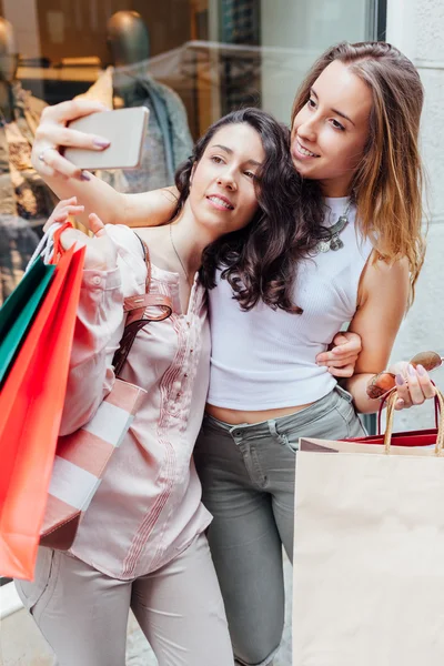Women making selfie after shopping