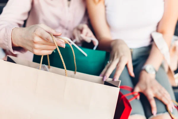Women opening shopping bags