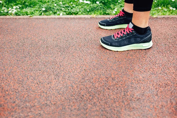 Runners legs on jogging track