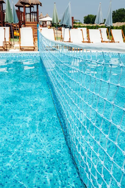 Swimming pool with a volleyball net