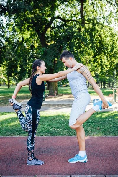 Smiling couple exercising outdoors
