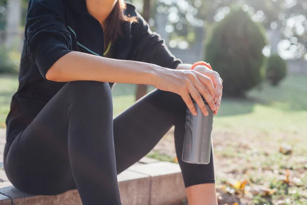 Runner having a rest to drink some water.