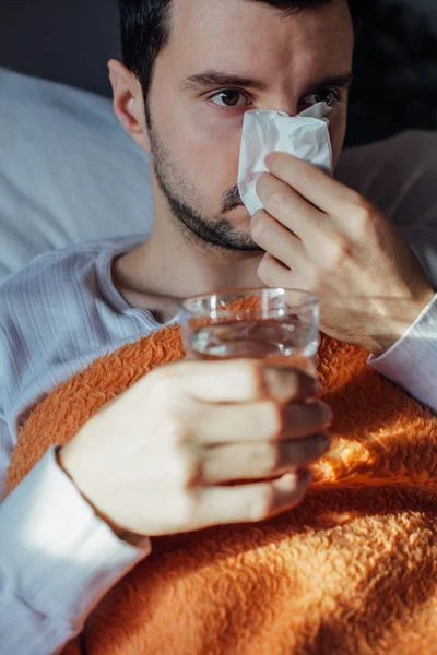 Sneezing man sick blowing nose