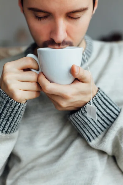 Man enjoying in a cup of hot tea
