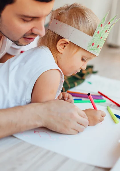 Dad teaches his daughter to draw