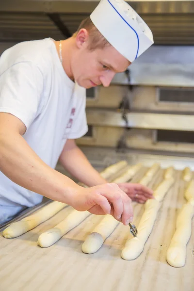 Baker making bread with his hands