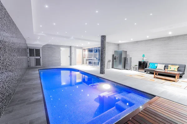 Relaxing indoor swimming pool with lighting