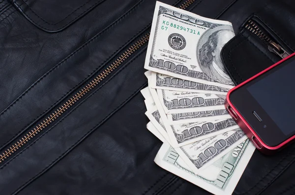 Money and phone near the pocket leather jacket