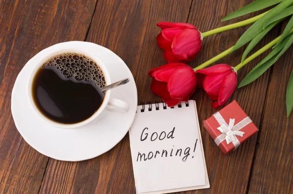 Cup of coffee, tulips and Good morning massage
