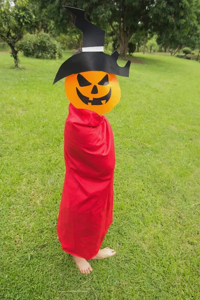 Little girls farmer play Halloween with pumpkin mask