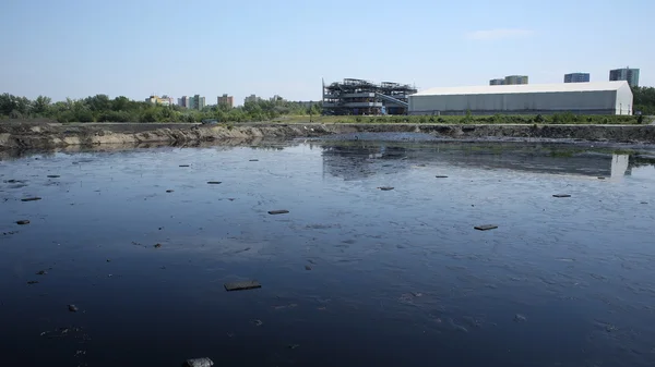 OSTRAVA, CZECH REPUBLIC - AUGUST 3, 2015: The former dump toxic waste in Ostrava, oil lagoon, Ostramo, effects nature from soil contaminated with chemicals and oil, Moravia-Silesia Region, Europe, EU