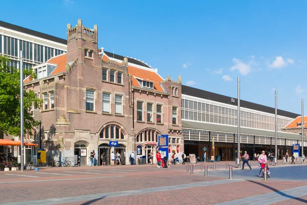 People and station building in Haarlem, Netherlands