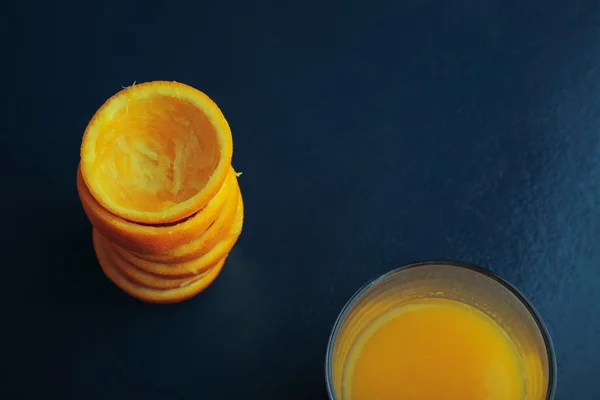 Citrus peels and juice glass isolated top view