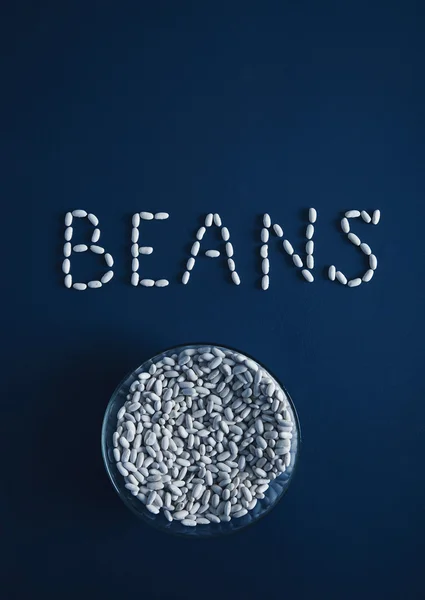 Heap white beans letters in bowl isolated