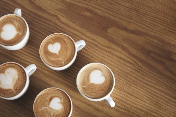 Six cappuccino cups isolated in corner