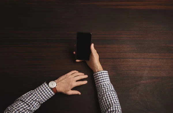 Accountant looking smart phone wearing  his classic silver watches