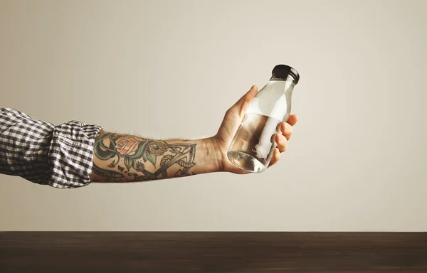 Hand holds bottle with clean water