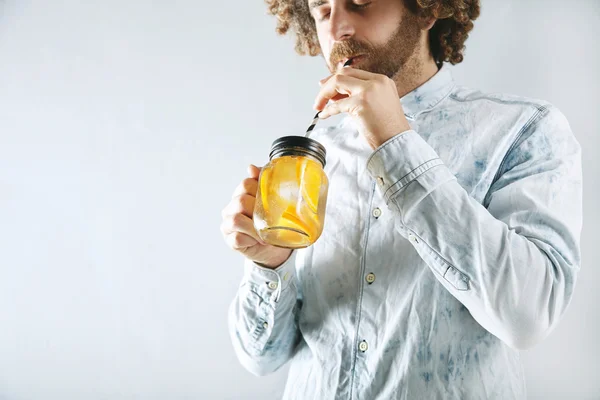 Man drinks fresh lemonade
