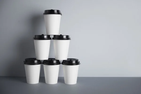 Pyramid made from six white take away paper cups