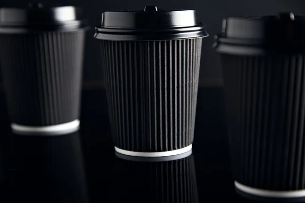 Black craft paper cups closed with caps