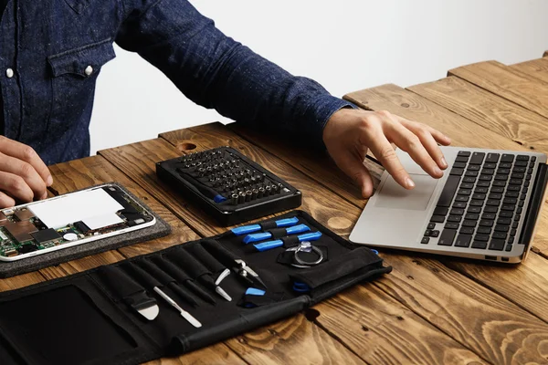 Man uses laptop to find internet guides