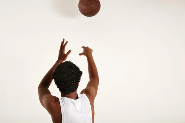 Handsome young African American throwing basketball