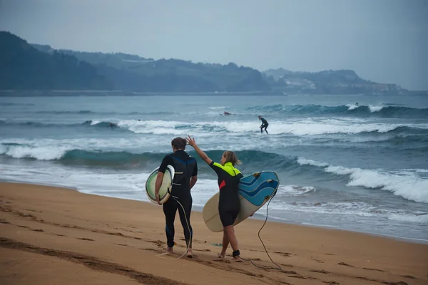 Surf couple walks and talks