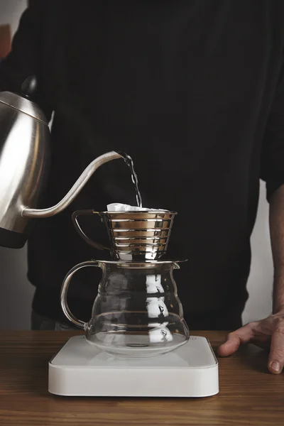 Barista spills boiled water in drip coffee maker