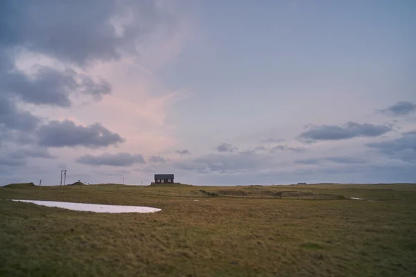 Tilt shift view on small farm house in field