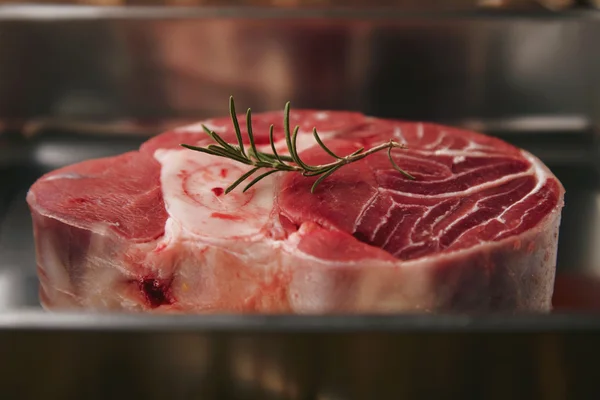 Closeup raw angus leg steak in silver steel pan