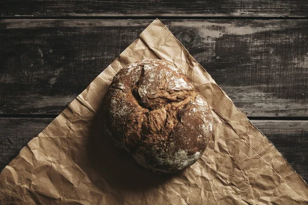 Rye whole grain round bread on brown craft paper