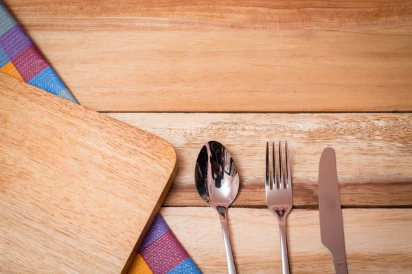 Fork, Knife and Table Cloth on wooden background. Top View
