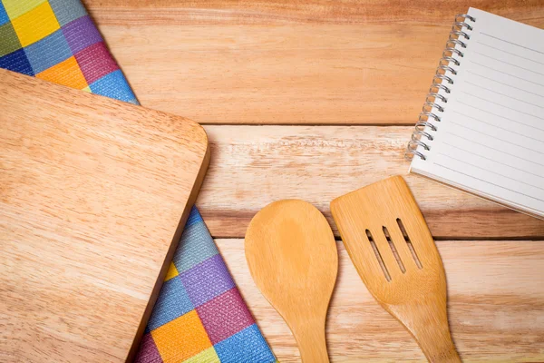 Fork, Knife,notebook diary and Table Cloth on wooden background.top view
