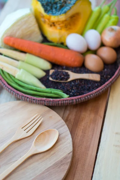 Clean food,vegetables set ,wood dish and wood fork on wooden tab