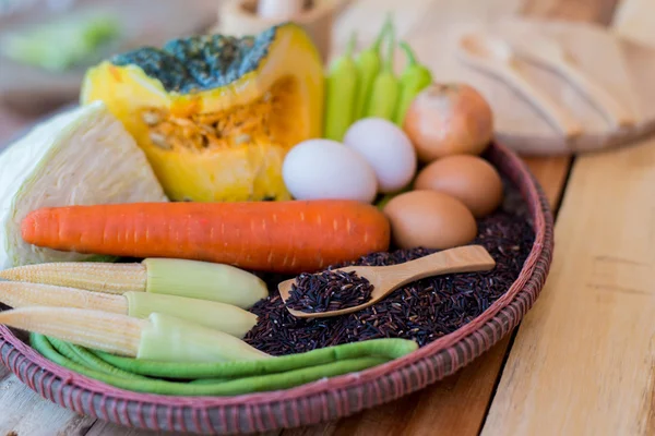 Clean food,vegetables set ,wood dish and wood fork on wooden table