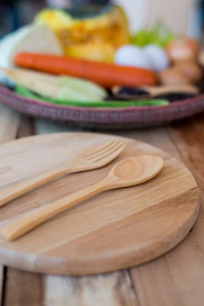 Clean food,vegetables set ,wood dish and wood fork on wooden table