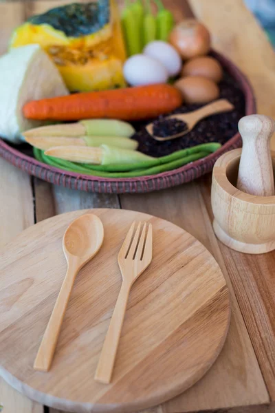 Clean food,vegetables set ,wood dish and wood fork on wooden table