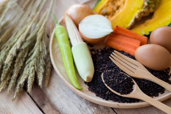 Clean food,vegetables set ,wood dish and wood fork on wooden table