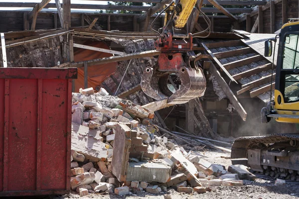 Demolition rubble in front of a demolished house