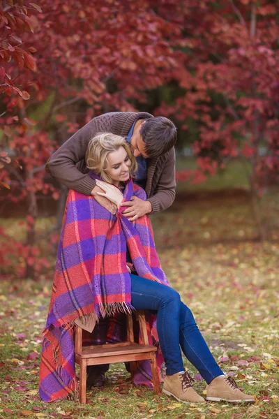 Loving man cares about his woman in autumn