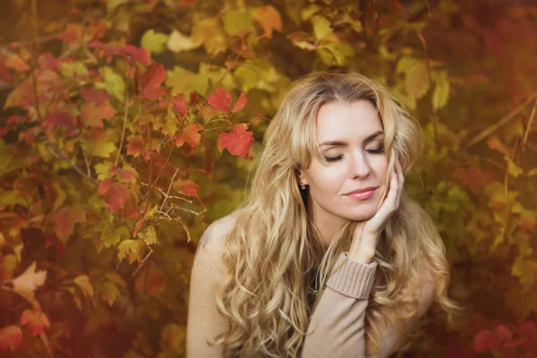 Portrait of beautiful young woman with melancholy in autumn