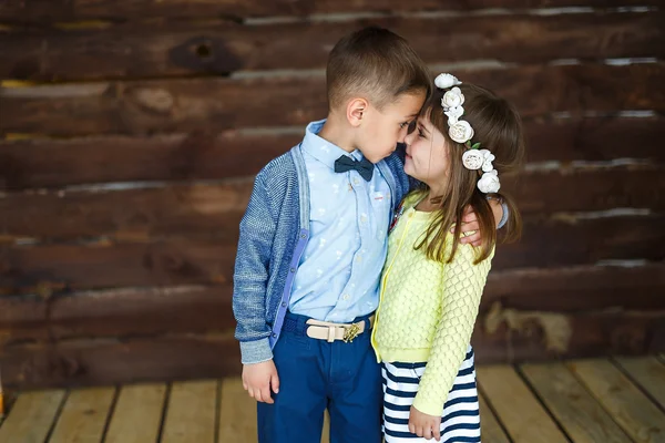 Little children stand and touch nose to nose