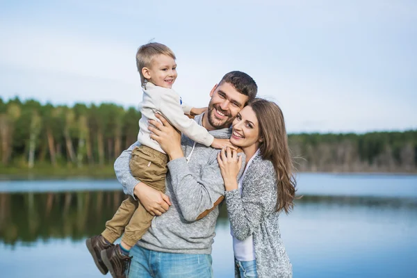 Portrait of a smilling young family on nature