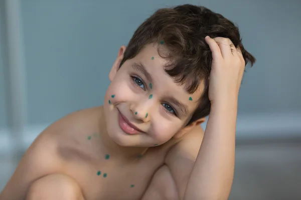 Portrait of a little boy with a green points