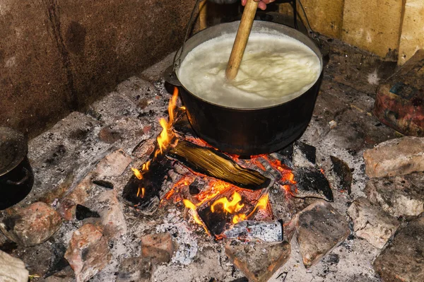 Cooking fires in a black iron pot