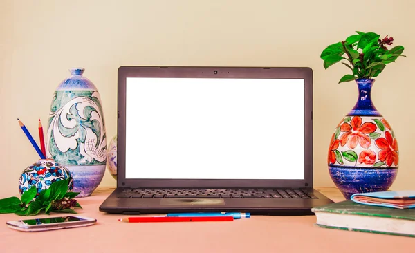 Laptop computer mock up with beautiful islamic style vases and p