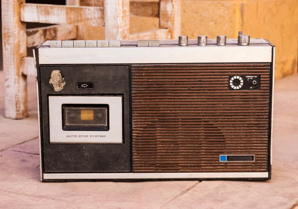 Antique radio on vintage stone grunge background, retro old phot